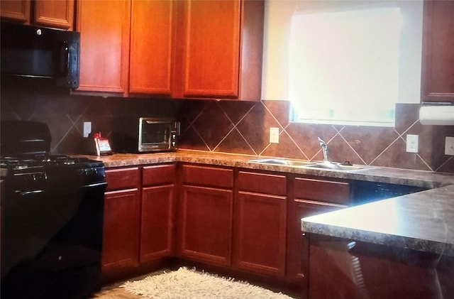 kitchen featuring sink, backsplash, and black appliances