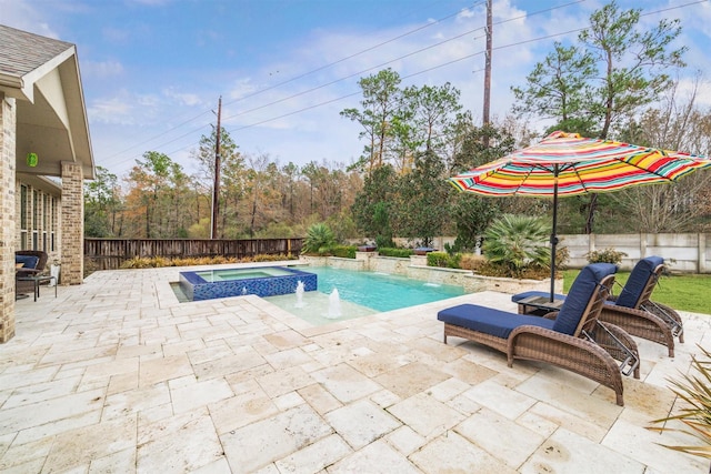 view of pool with a patio area, pool water feature, and an in ground hot tub