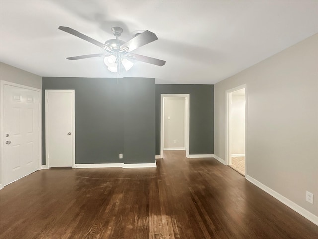 interior space with ceiling fan and dark hardwood / wood-style floors