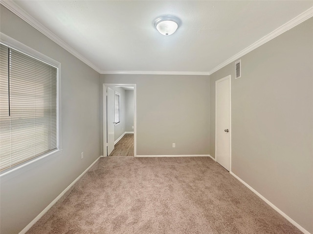 unfurnished bedroom with crown molding and carpet