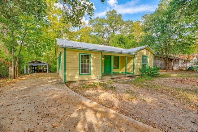 view of front of home with a carport and covered porch