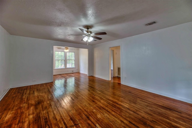 unfurnished room featuring ceiling fan, wood-type flooring, and a textured ceiling