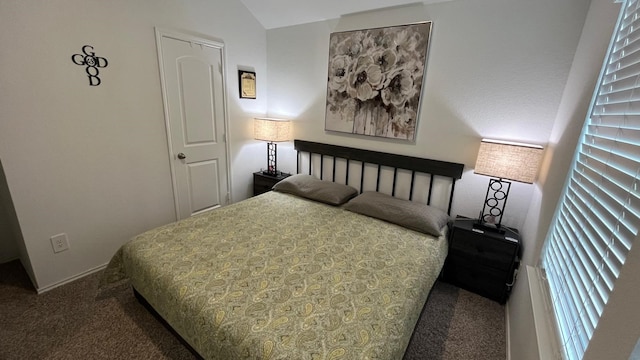 carpeted bedroom featuring lofted ceiling