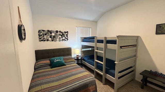 carpeted bedroom with lofted ceiling