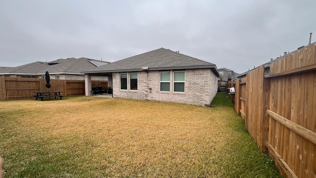 rear view of property with a yard