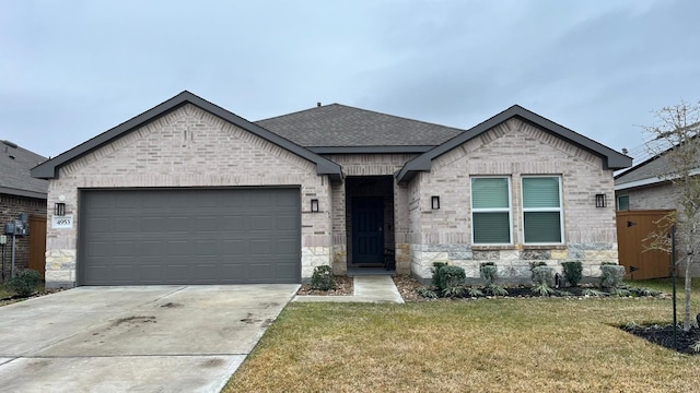 view of front of property with a garage and a front lawn