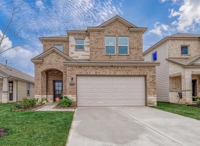 view of front of house with a garage and a front yard