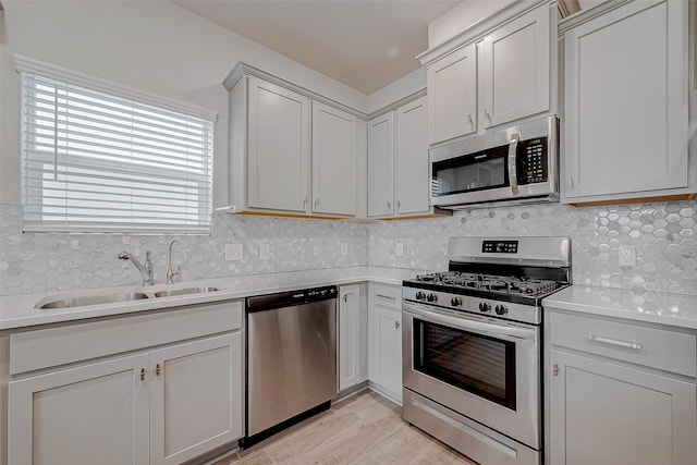 kitchen with stainless steel appliances, tasteful backsplash, and sink