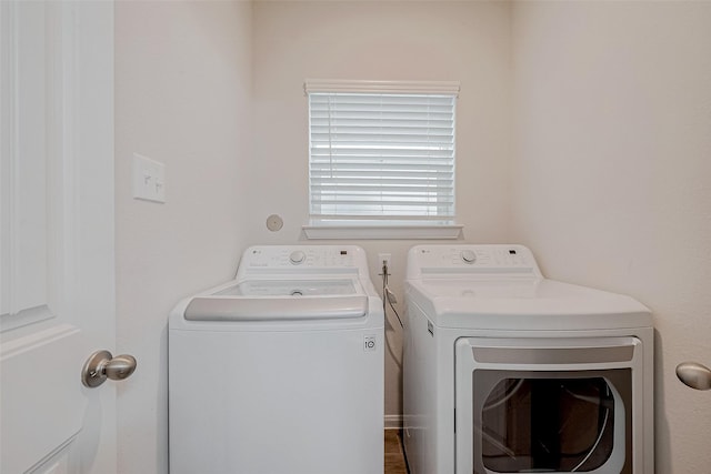 clothes washing area with washer and clothes dryer