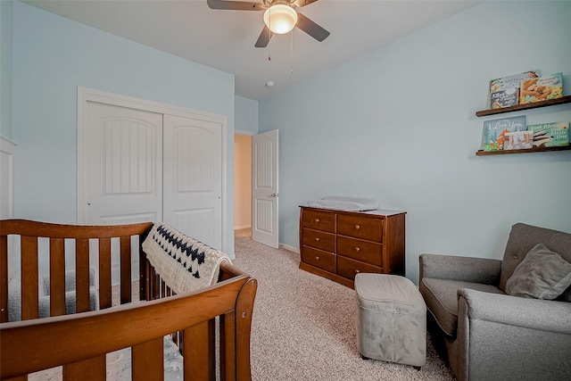 carpeted bedroom featuring ceiling fan and a closet