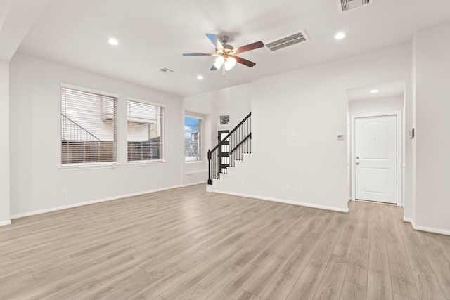 unfurnished living room with ceiling fan and light hardwood / wood-style floors