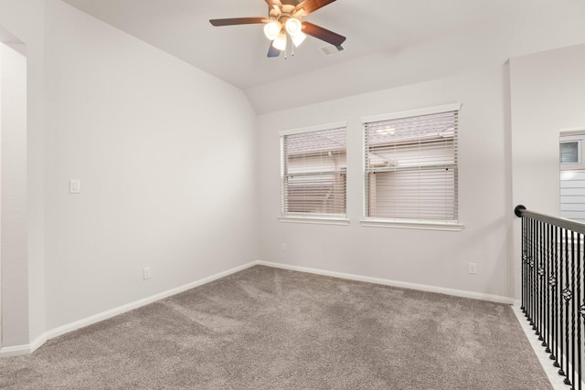 unfurnished room featuring lofted ceiling, carpet flooring, and ceiling fan