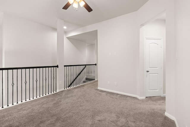 empty room with carpet floors and ceiling fan