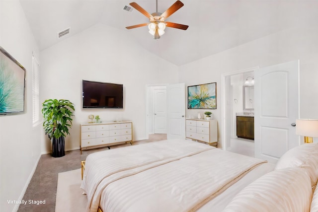 bedroom with ceiling fan, high vaulted ceiling, light carpet, and ensuite bath