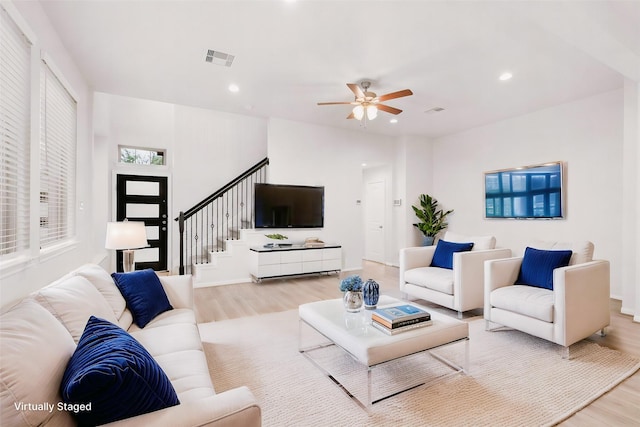 living room featuring ceiling fan and light wood-type flooring