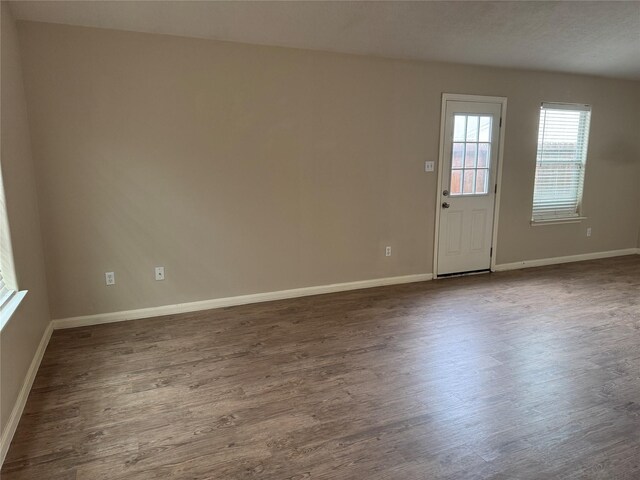 spare room with dark hardwood / wood-style floors