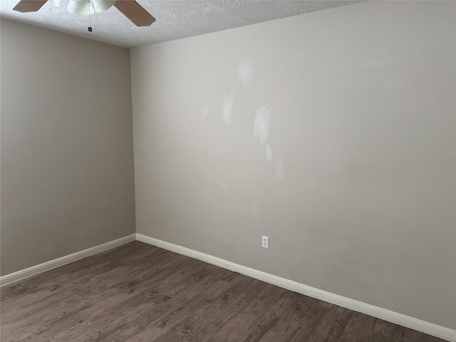 spare room with ceiling fan, dark hardwood / wood-style flooring, and a textured ceiling