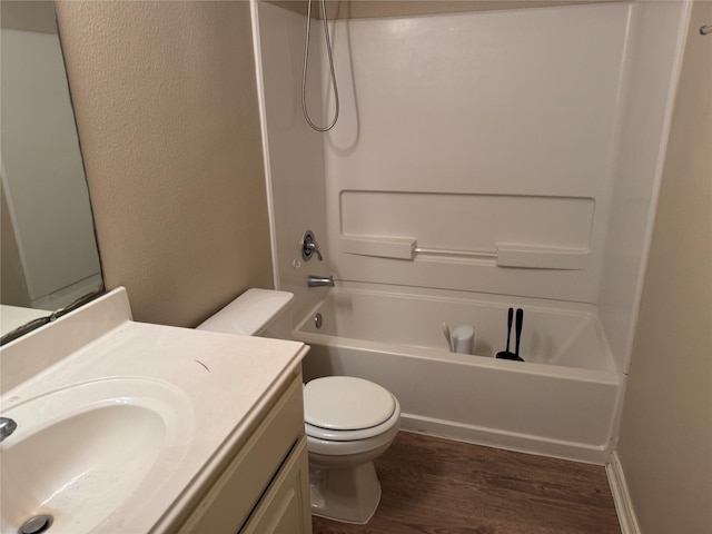 full bathroom with hardwood / wood-style flooring, shower / bath combination, vanity, and toilet