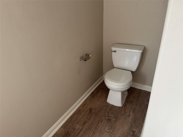 bathroom featuring hardwood / wood-style floors and toilet