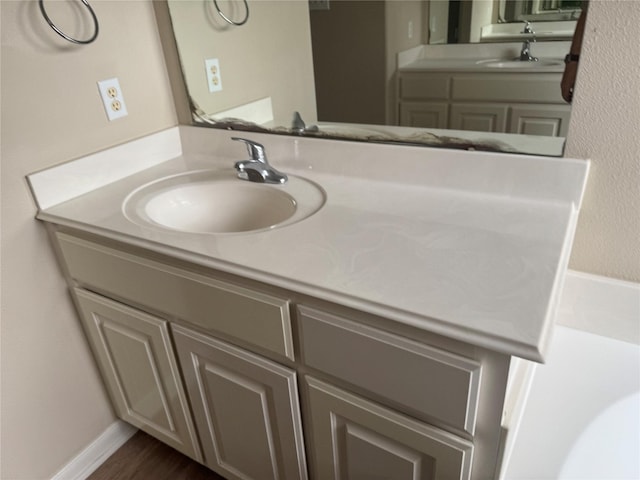 bathroom with vanity and hardwood / wood-style floors