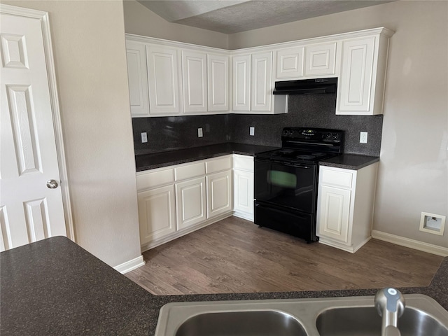 kitchen featuring sink, black electric range oven, dark hardwood / wood-style floors, white cabinets, and decorative backsplash