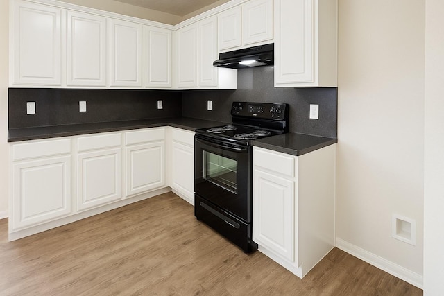 kitchen with black / electric stove, under cabinet range hood, dark countertops, baseboards, and light wood finished floors