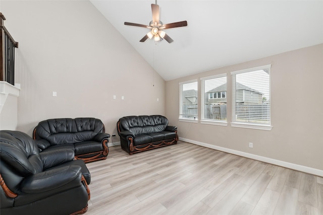 living room with light hardwood / wood-style flooring, high vaulted ceiling, and ceiling fan