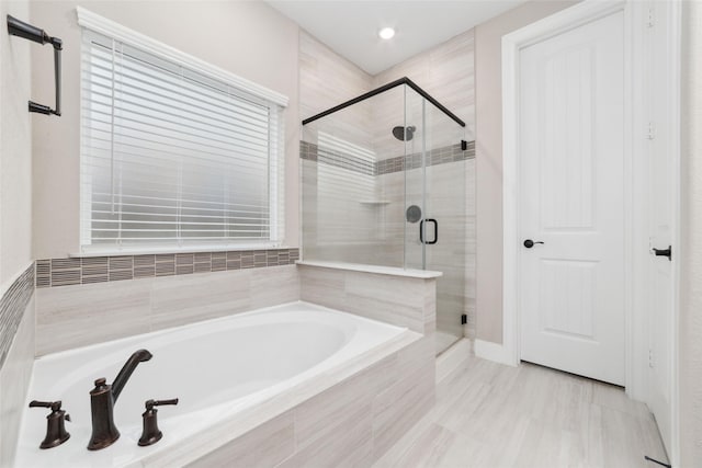 bathroom featuring plus walk in shower and tile patterned flooring