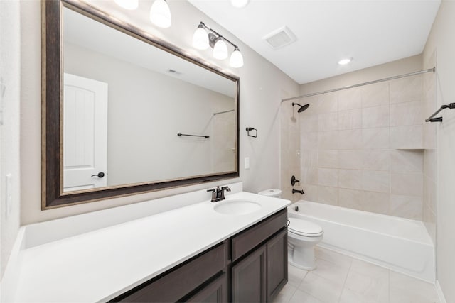 full bathroom featuring vanity, tile patterned floors, toilet, and tiled shower / bath