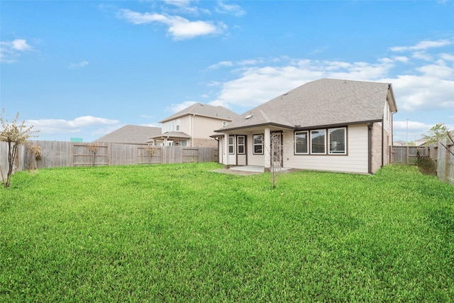 back of house with a yard and a patio area