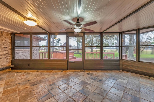 unfurnished sunroom with wood ceiling and ceiling fan