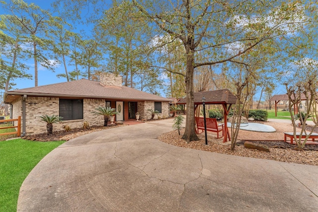 ranch-style home featuring a gazebo and a front lawn