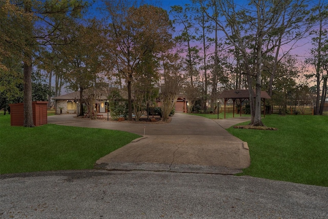 view of front facade featuring a lawn and a carport