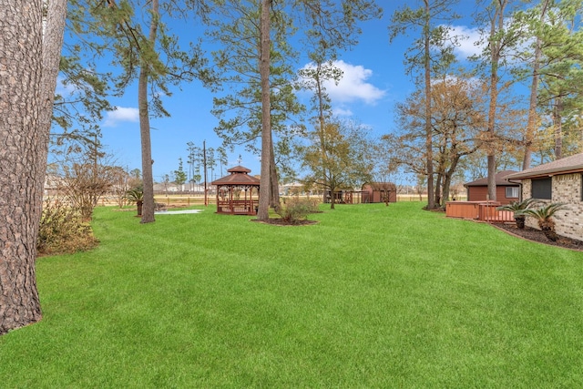 view of yard featuring a wooden deck and a gazebo