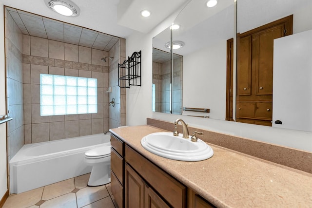 full bathroom featuring tiled shower / bath combo, vanity, tile patterned floors, and toilet