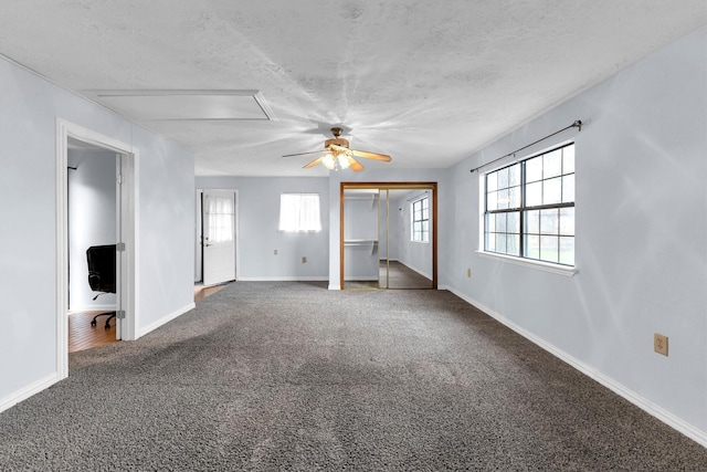 empty room with carpet floors and a textured ceiling