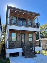 view of front of house with a porch and a balcony