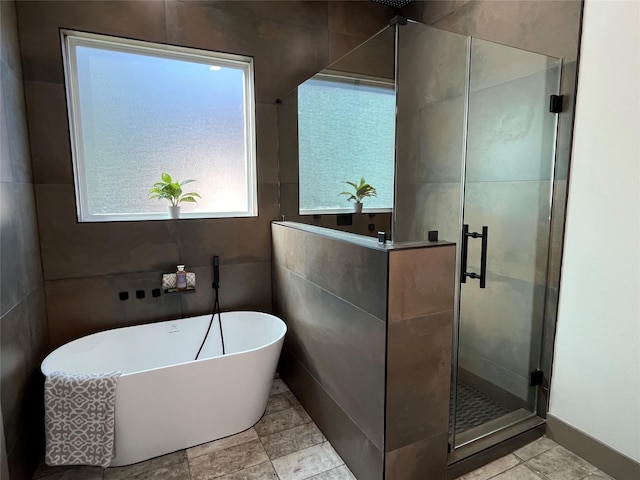 bathroom featuring shower with separate bathtub