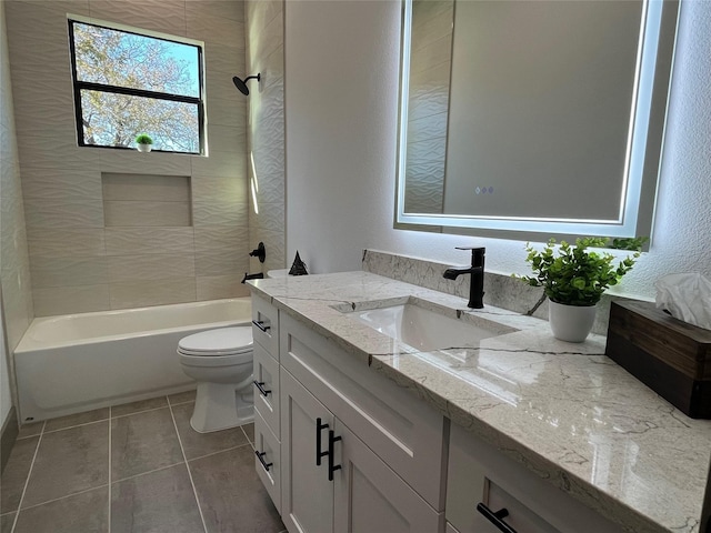 full bathroom featuring tiled shower / bath, vanity, toilet, and tile patterned flooring