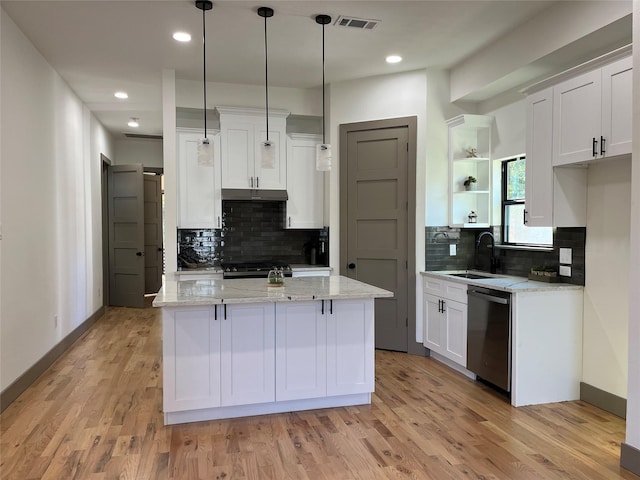 kitchen with pendant lighting, light stone countertops, white cabinets, and appliances with stainless steel finishes