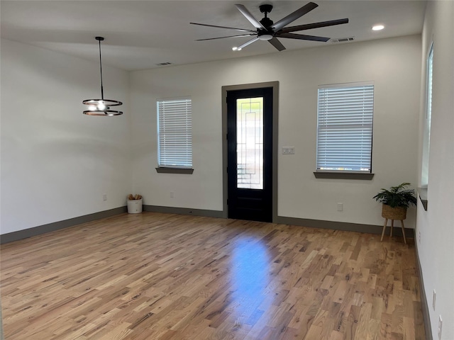 entrance foyer with ceiling fan and wood-type flooring