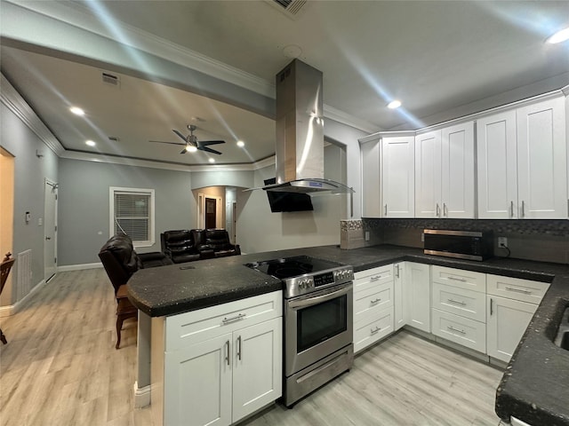 kitchen featuring white cabinetry, appliances with stainless steel finishes, island range hood, and kitchen peninsula