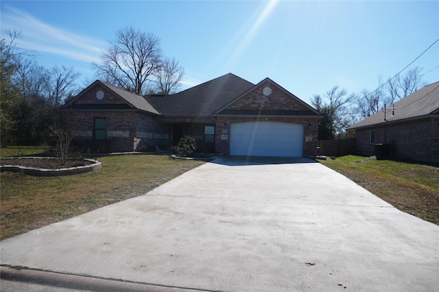 ranch-style house featuring a garage and a front yard