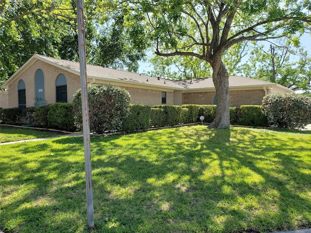 view of side of property with a lawn