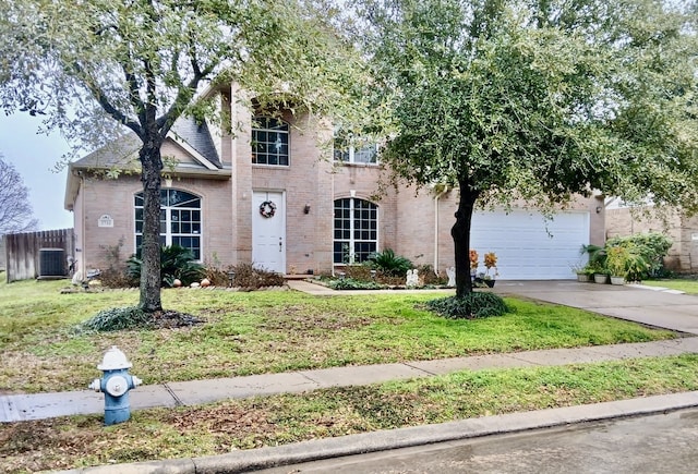 view of front of house featuring a garage, a front yard, and central air condition unit