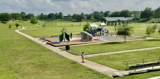 view of home's community with a yard and a playground