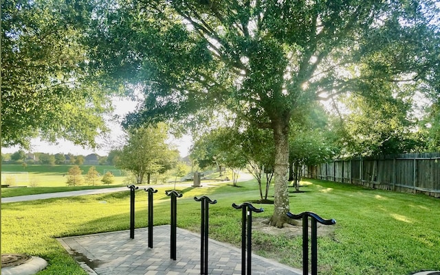 surrounding community featuring a lawn and a patio area