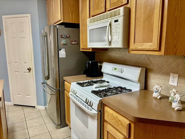 kitchen with light tile patterned floors and white appliances