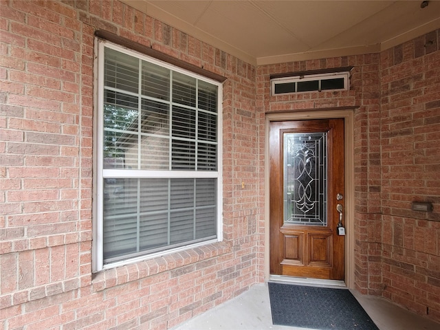 property entrance with brick siding