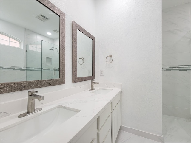 bathroom featuring double vanity, a stall shower, a sink, and visible vents